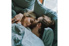 Image Couple laying in bed prepared to sleep